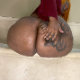 A big, black woman woman sits on the edge of a bath tub while taking a runny shit onto the floor. She glances back at the camera revealing her face. Presented in 720P HD. About 2 minutes.